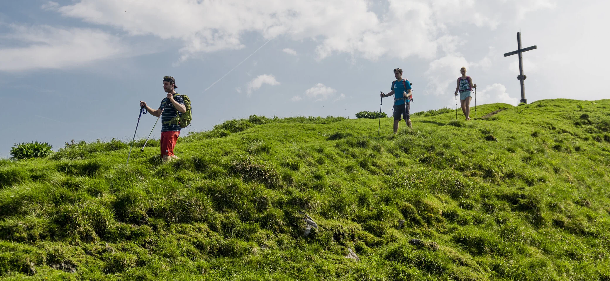 Wandern in den Chiemgauer Alpen | © DAV/Hans Herbig Drei Wanderer auf den grünen Berghängen der Chiemgauer Alpen | © DAV/Hans Herbig